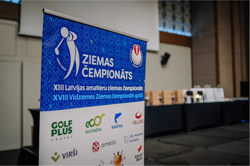 Trade show Vinyl Banner with sponsor logos set up at the front of an event room